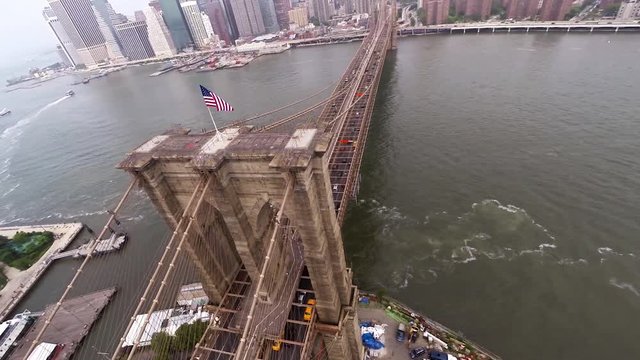 Wide aerial drone shot above the Brooklyn Bridge in New York City.