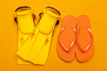 Yellow swimming flippers on colored background