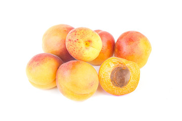 Fresh sweet apricot fruit, whole and half, group of juicy ripe apricots closeup, isolated on the white background