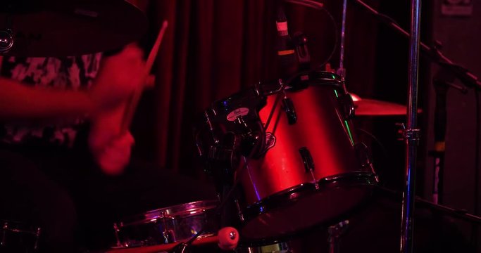 Close up of drums being played by a drummer performing on stage