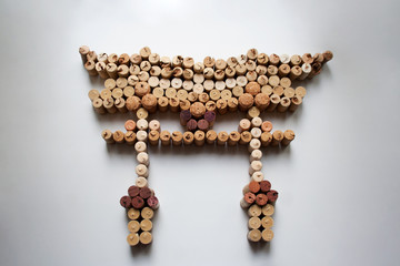 Wine corks floating torii gate abstract composition isolated on white background from a high angle view