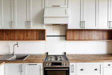 Stylish light gray kitchen interior with modern cabinets and stainless steel appliances. kitchen...