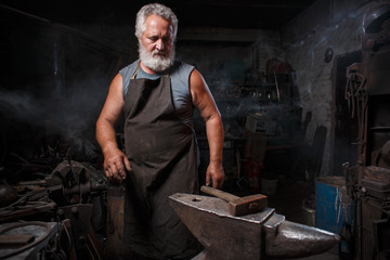 Blacksmith with brush handles the molten metal