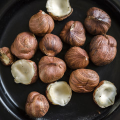 Hazelnuts nuts in bowl. Food background. Close up