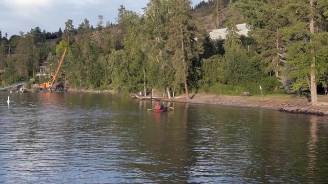 Slow Motion Two People in Canoe Approaching Shoreline