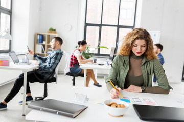 Fototapeta premium business, technology and people concept - creative woman or developer working on user interface design at office