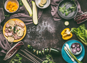 Preparation of Chicken with vegetables cooking on rustic background with fresh ingredients , plates, bowls and kitchen tools, top view, flat lay.  Food, eating and cooking concept , frame