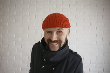 guy with a mustache in a red knitted hat