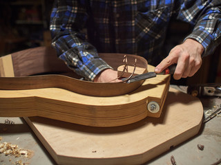 The process of making a classical guitar. Giving the sides of the guitar the right shape.