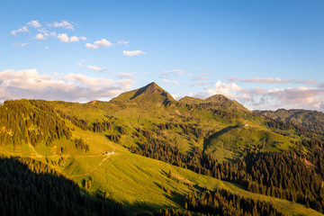 Sonnenuntergang am Berg mit blauem Himmel und Ausblick auf den Gipfel im Sommer