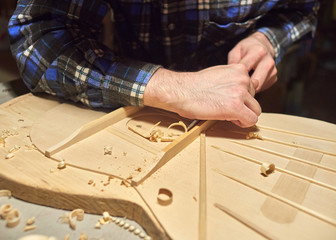 The process of making a classical guitar. Making the right shape of a brace guitar.