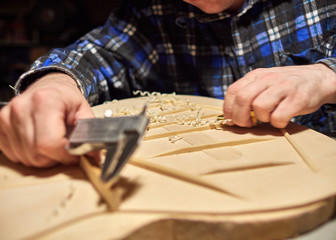 The process of making a classical guitar. Making the right shape of a brace guitar.