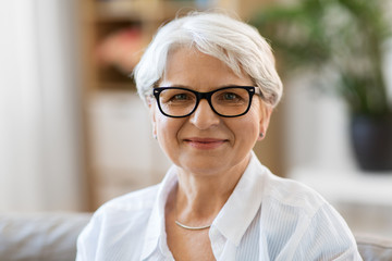 vision, age and people concept - portrait of happy senior woman in glasses