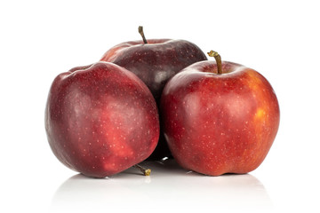 Three red delicious apples isolated on white background deep red.