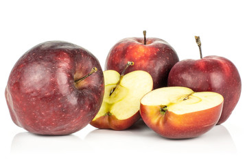 Red delicious three apples and two halves isolated on white background.