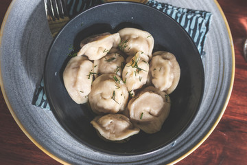 Homemade meat dumplings, russian pelmeni. Top view, copy space.