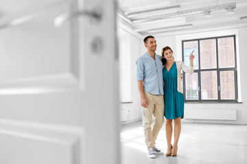 Fototapeta premium mortgage, people and real estate concept - happy couple hugging at new home