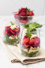 Spinach salad in glass.