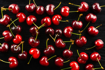 Sweet bright red cherry fresh flatlay on black wood...........................................................................
