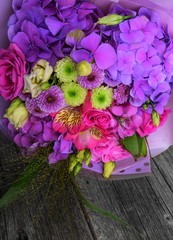 Beautiful flower bouquet on the wooden table.