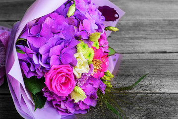 Beautiful flower bouquet on the wooden table.