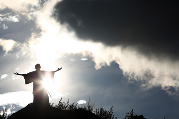 Silhouette monk on the mountain prayer moses faith god - obrazy, fototapety, plakaty