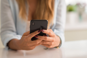 Woman using smartphone at home