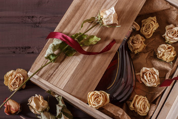 a bottle of chic cognac in a wooden box with a rose