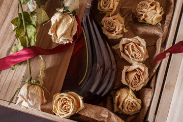 a bottle of chic cognac in a wooden box with a rose