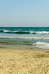 Beach of Black Sea from Mamaia, Romania with blue clear water and golden sands