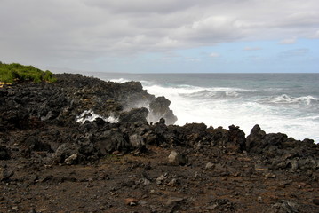 Reunion island seascape, landscape. Black sand, volcanic rocks.