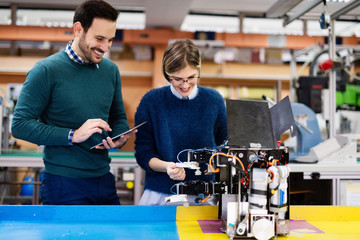 Young students of robotics working on project