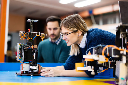 Young students of robotics working on project
