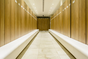 Modern Storage lockers in a swimming pool with bench , and led lighting.