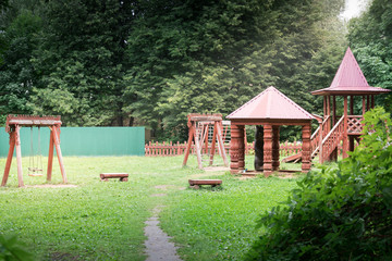 Modern unusual bright wooden playground (children's lodge) in the new suburban residential complex.