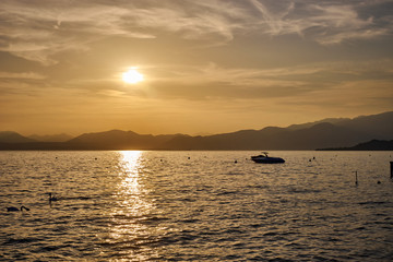 Spectacular sunset with beautiful light at City of Bardolino / Lake Garda in Italy