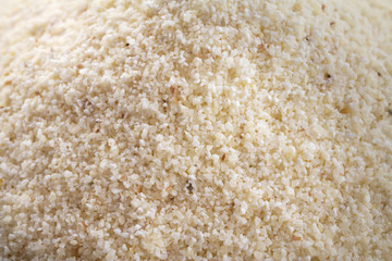 Macro shot of semolina, white wheat farina - healthy groats and cereal. Closeup.