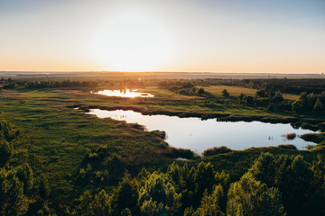 Aerial panoramic view to beautiful nature landscape at sunset, green forest, lake, awesome nature background