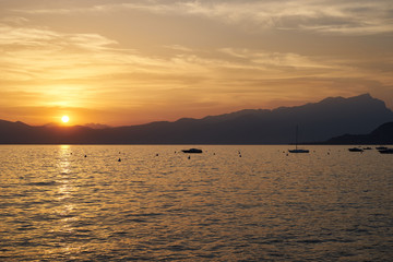 Spectacular sunset with beautiful light at City of Bardolino / Lake Garda in Italy