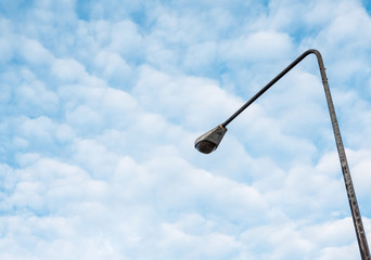 Street light pole under the couldy sky.