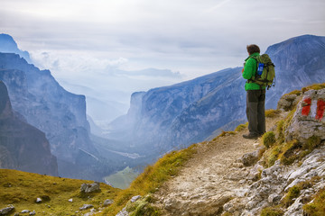 Fototapeta na wymiar Young adventurer standing on a cliff