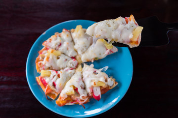 Pizza home made in dish on wooden table