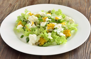 Salad with corn, greens, feta with mayonnaise sauce