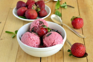 Strawberry ice cream with fresh berries, mint and chocolate chips