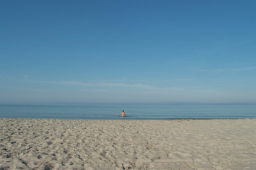 Fototapeta na wymiar man enjoys relaxing on a secluded beach