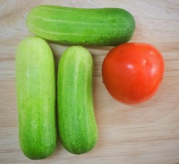 Fresh Tomato with Cucumbers on Cutting Board
