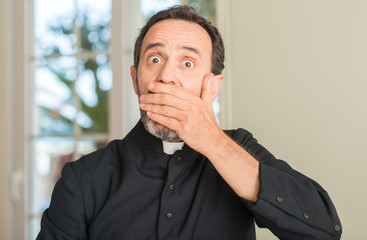 Christian priest man cover mouth with hand shocked with shame for mistake, expression of fear,...