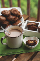 Fudge brownie cookies with penut and cheese filling with cacao on the mug