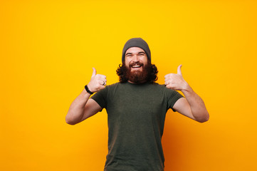 happy funny bearded man show sight thumbs up and good luck