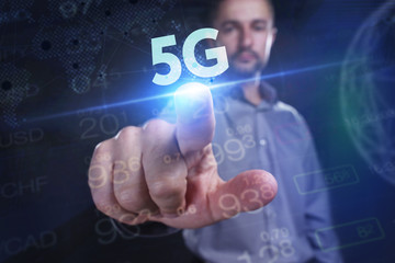 The concept of business, technology, the Internet and the network. A young entrepreneur working on a virtual screen of the future and sees the inscription: 5G